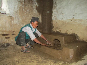 HHC employee, Bin Tapa finishing a cookstove