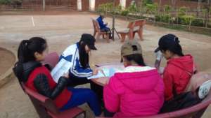 The girls are reading in the school yard