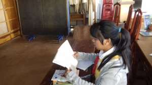 A tribal girl studying alone during lunch break