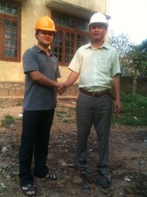 Tam of GCSF with contractor at building site