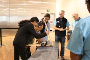 A team tests their device for the judges