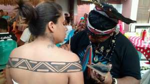 Benicio painting Ruth with indigenous art