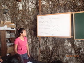 Jacqueline teaching English to her schoolmates