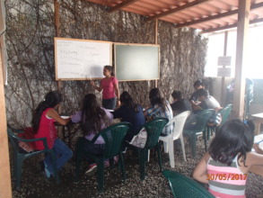 Jacqueline teaching English to her schoolmates
