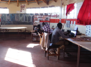 Noah teaches two students at EWRC computer lab