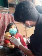Salma and her plushie, ready for checkup time