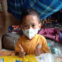 Happy Hadi with a bag of diapers from Rachel House