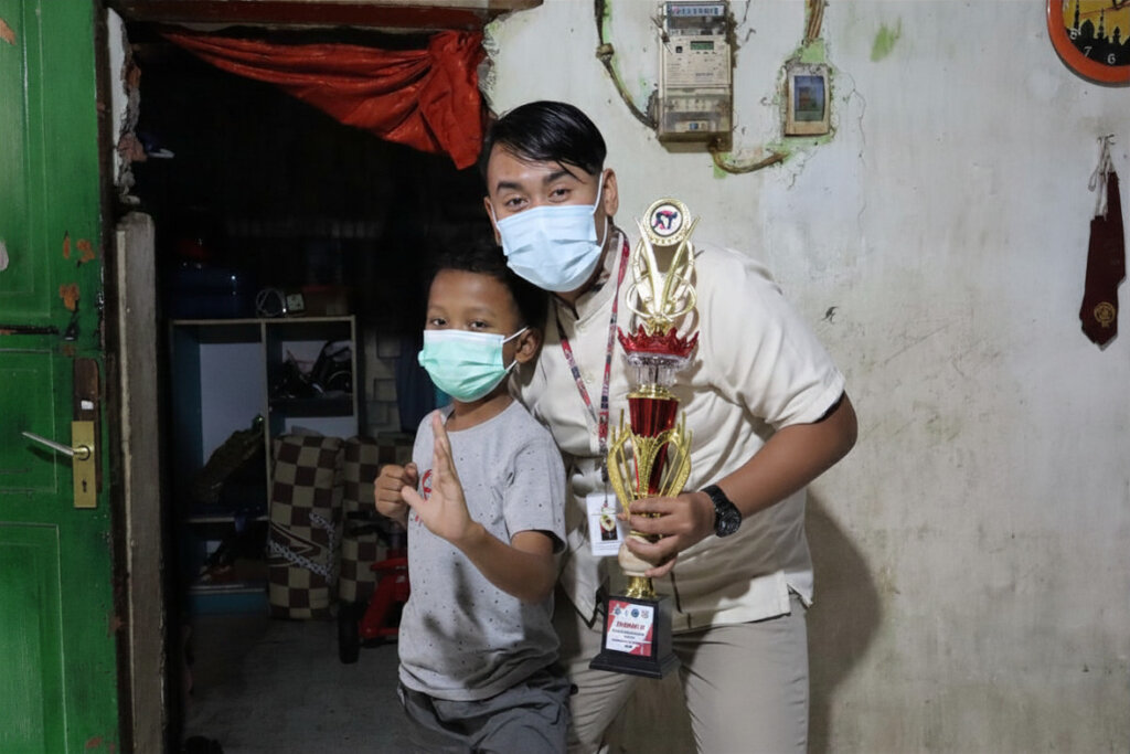 Fahmi, his glorious trophy, and our nurse.