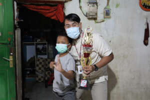 Fahmi, his glorious trophy, and our nurse.