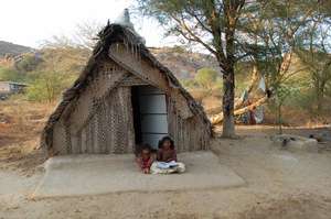 GIRL CHILDREN OUTSIDE THEIR HOME