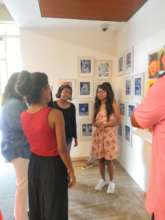 Pooja, the artist Showing her Painting