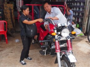 Pisey learns how to work the mechanics of the bike