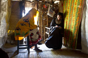 Loan officer with a poor woman in her house