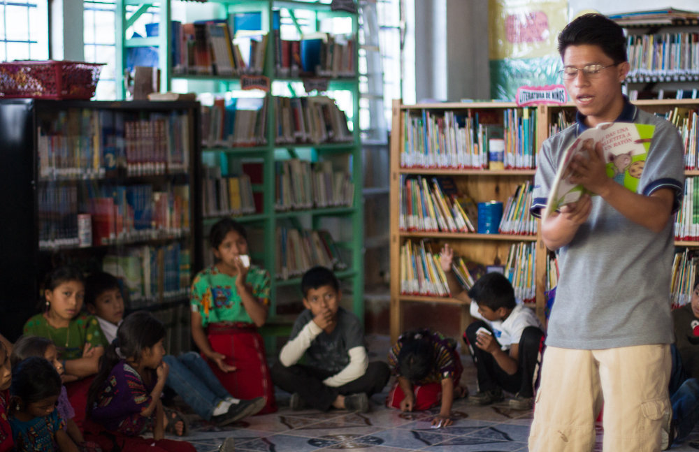 Librarian Eduardo Rey leads story hour