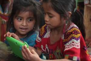 Library users playing with a new tablet