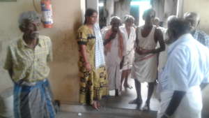 A group of inamates discussing on food with cook