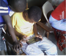 Kids In Our Youth Program Learning To Use A Tablet
