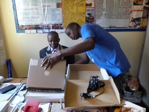 Headmaster Receiving Laptops From The Foundation