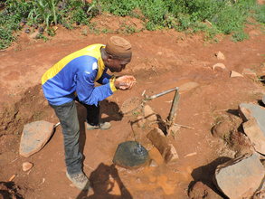 volunteer enjoys a cool drink after work