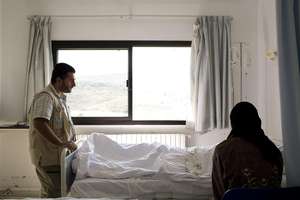 UNHCR worker counsels an injured displaced Syrian