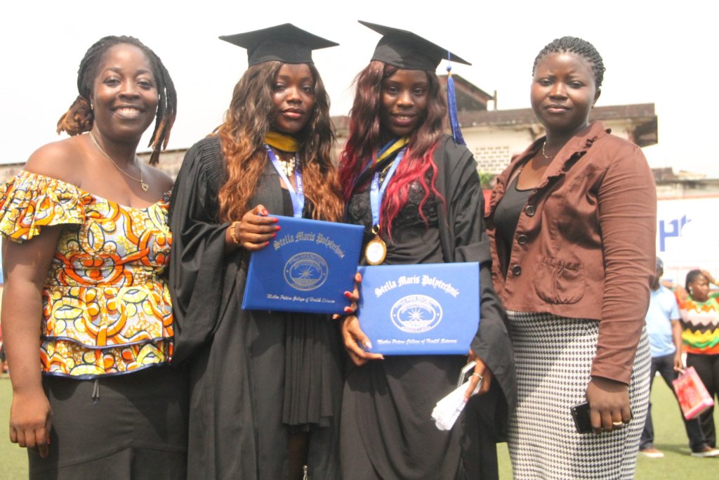 Graduates Patience (R) & Nowoe (L) w/Program Staff