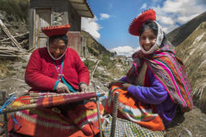 Cristina and Yolanda work together on a textile.