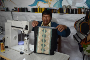 Sr.Tomas proudly shows us his sewing progress