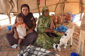 Aicha (in green) shelters from the sun