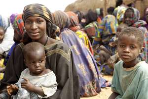 A Malian family waits for relief items from UNHCR.