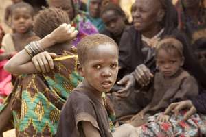 A Malian refugee boy waits at an aid distribution