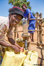 Filling up at a new well in Pallisa, Uganda
