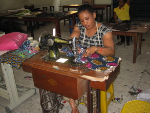 Obioma on her machine sewing her wear