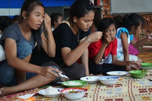 Higher grade school children eating at Riverkids