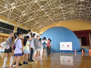 The visitors wait in line to see the planetarium.