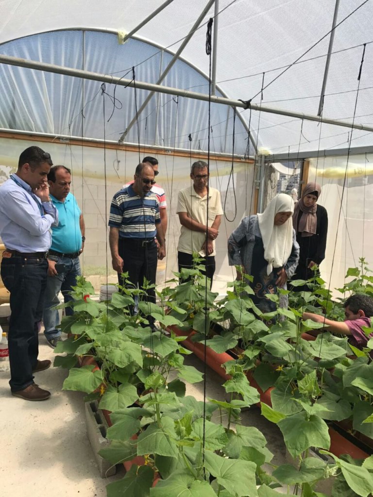 Officials visit a participating refugee