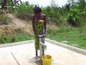 A woman drawing water from a well in Ghana.