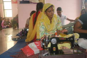 Kamlesh sewing dress during training