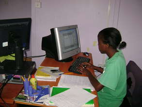Mentee being trained on computer skills