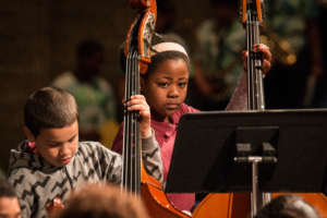 Two bassists concentrate on their music making!