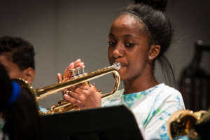 A trumpeter plays with dedication!