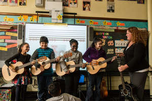 Students enjoy a guitar lesson!