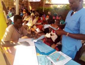 A student recording vaccination records.