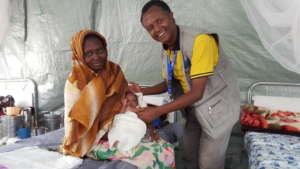 Dr. Tek with a new mother and her newborn baby
