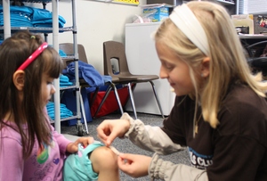 Aspiring pediatrician Nina helps a younger child