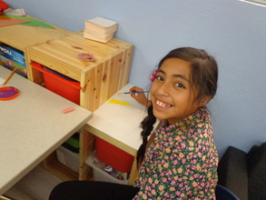 Jocelyn paints in the Oak View Branch Ed Room