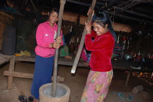 Cherbb and her sister husking rice