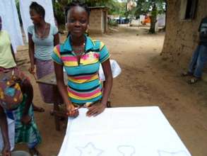 Aminata works on her wax design