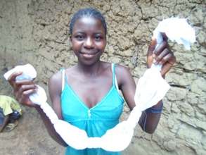 Baindu holds her birds-eye tied fabric