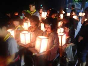 launching a straw floatable lantern on the water