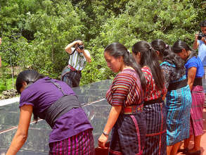 Mayan girls examining solar panels
